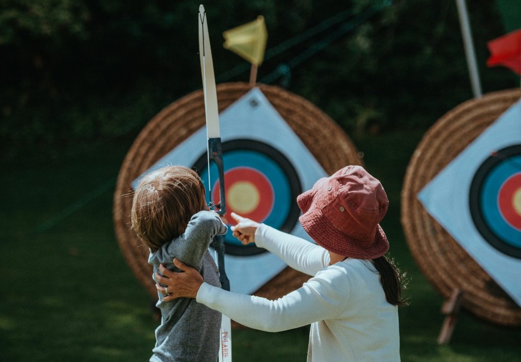 Kid playing archery at party