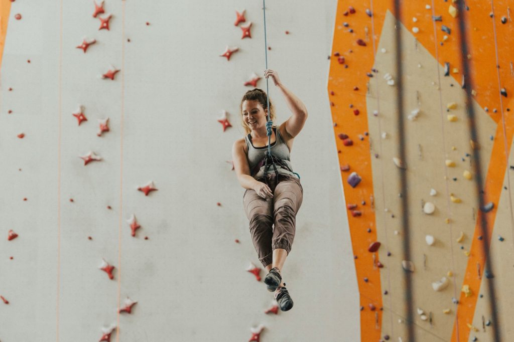 Women rock climbing, team building acivity.